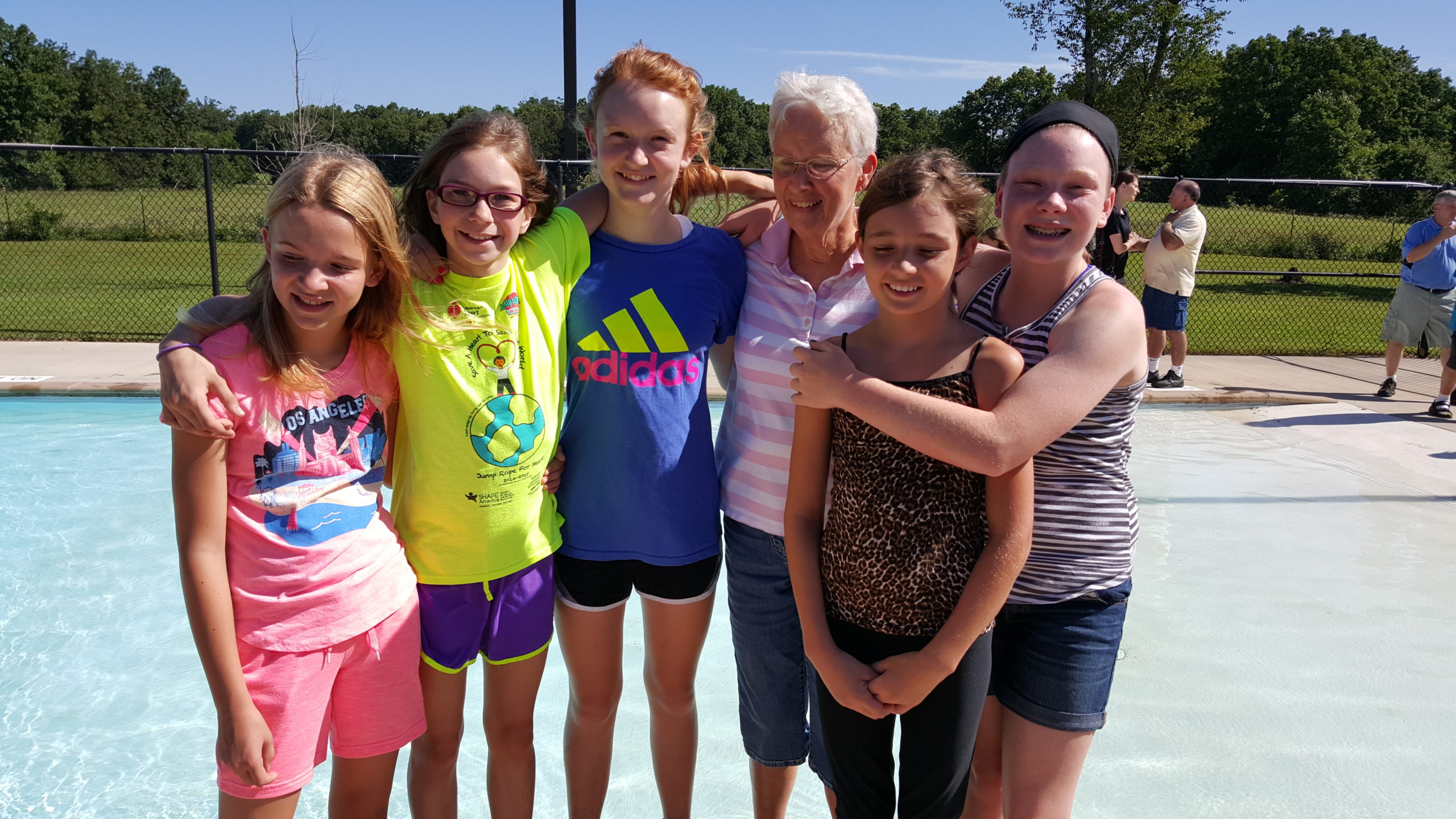 A Group of Girls Gathered by a Pool, Enjoying Their Time Together Under the Sun.
